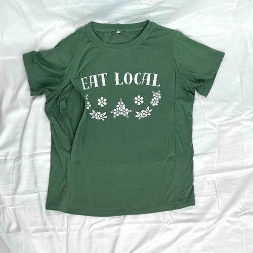A green short-sleeve t-shirt with 'EAT LOCAL' and a floral pattern printed in white, nursing side zip access highlighted.